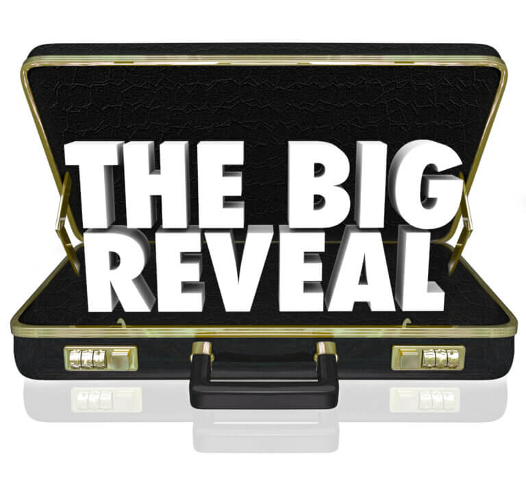 the words the big reveal in large white text appear in an open suitcase