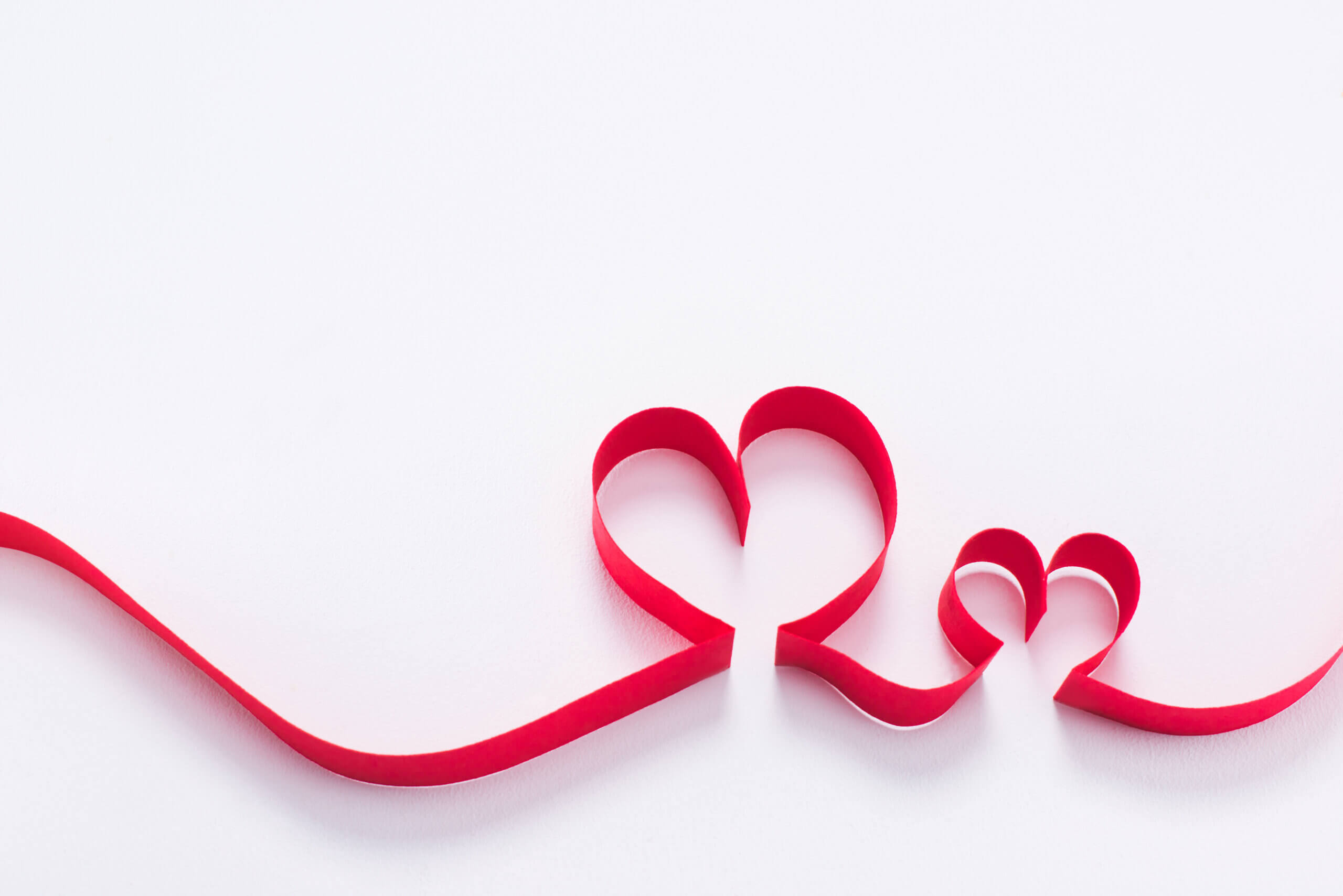 red ribbon showing a larger heart and a smaller heart